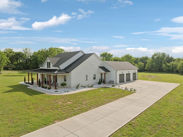 2648 Wilson Overall Rd, Murfreesboro, TN 37127 - view of front facade featuring covered porch, an attached garage, driveway, a standing seam roof, and a front lawn