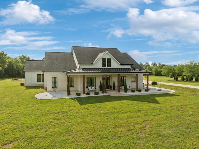 2648 Wilson Overall Rd, Murfreesboro, TN 37127 - rear view of property featuring a standing seam roof, covered porch, a yard, and metal roof