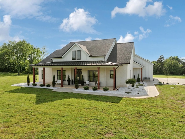 2648 Wilson Overall Rd, Murfreesboro, TN 37127 - back of house with covered porch, a standing seam roof, a lawn, a shingled roof, and metal roof