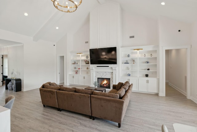 2648 Wilson Overall Rd, Murfreesboro, TN 37127 - living area with high vaulted ceiling, baseboards, a chandelier, built in features, and light wood-style flooring