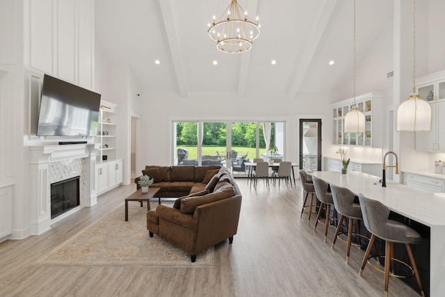 2648 Wilson Overall Rd, Murfreesboro, TN 37127 - living room featuring high vaulted ceiling, light wood finished floors, beam ceiling, a chandelier, and a fireplace