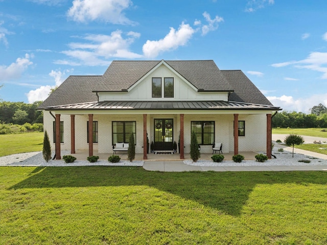 2648 Wilson Overall Rd, Murfreesboro, TN 37127 - modern inspired farmhouse with a standing seam roof, a porch, a front yard, and a shingled roof