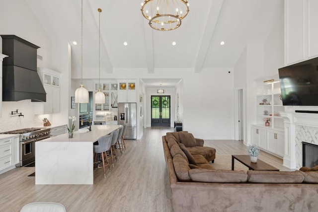 2648 Wilson Overall Rd, Murfreesboro, TN 37127 - living area with high vaulted ceiling, a chandelier, light wood finished floors, beam ceiling, and a fireplace
