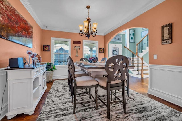 3112 Timberdale Dr, Clarksville, TN 37042 - dining room with ornamental molding, a chandelier, dark wood-style flooring, a wainscoted wall, and arched walkways