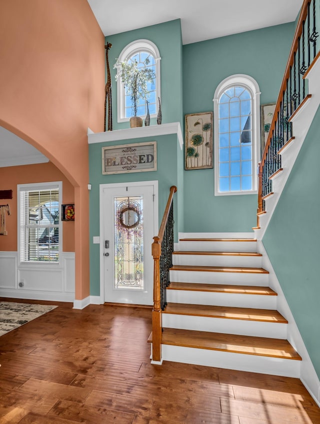 3112 Timberdale Dr, Clarksville, TN 37042 - entrance foyer with a wainscoted wall, wood finished floors, stairs, arched walkways, and a towering ceiling
