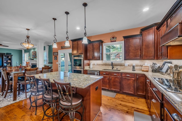 3112 Timberdale Dr, Clarksville, TN 37042 - kitchen with a sink, appliances with stainless steel finishes, light stone countertops, tasteful backsplash, and a center island