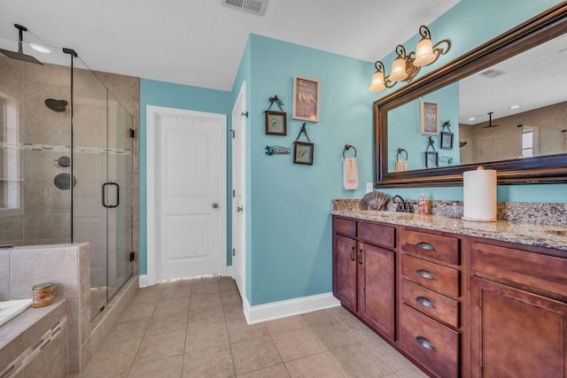 3112 Timberdale Dr, Clarksville, TN 37042 - bathroom featuring a shower stall, vanity, tile patterned floors, baseboards, and a relaxing tiled tub