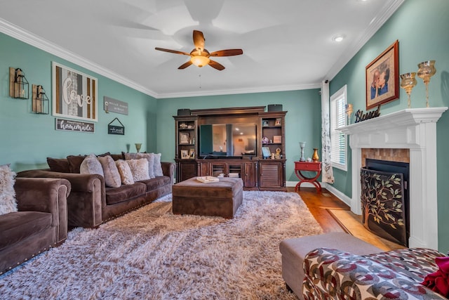 3112 Timberdale Dr, Clarksville, TN 37042 - living room with a ceiling fan, crown molding, wood finished floors, a fireplace with flush hearth, and recessed lighting