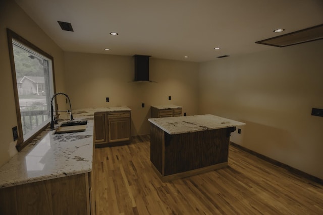 310 E 15th St, Columbia, TN 38401 - kitchen with wall chimney exhaust hood, light wood-style floors, a sink, recessed lighting, and light stone countertops
