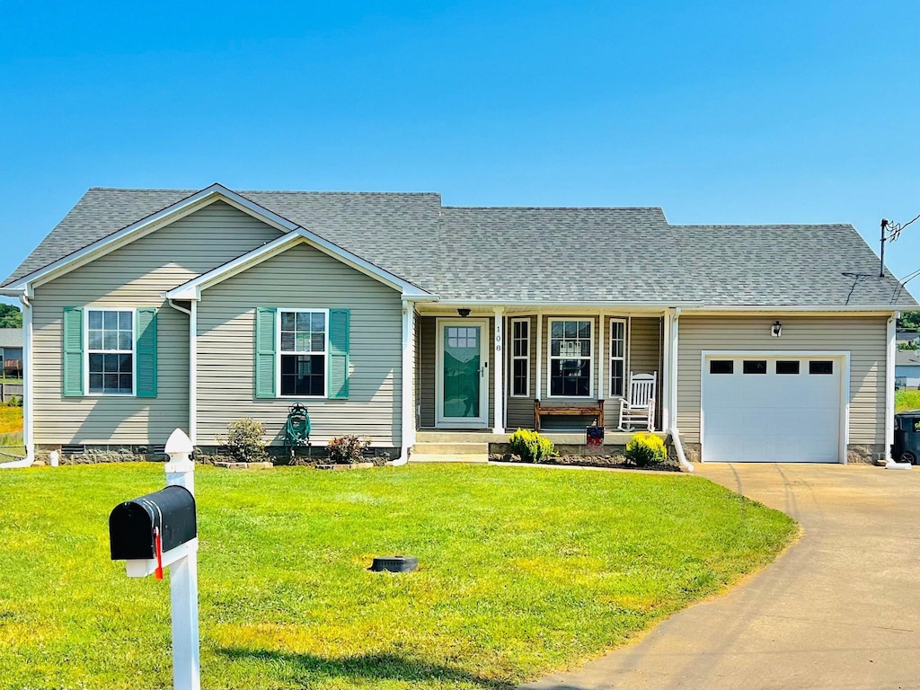 108 Josephines Ct, Oak Grove, KY 42262 - view of front of house with an attached garage, covered porch, concrete driveway, a front lawn, and a shingled roof