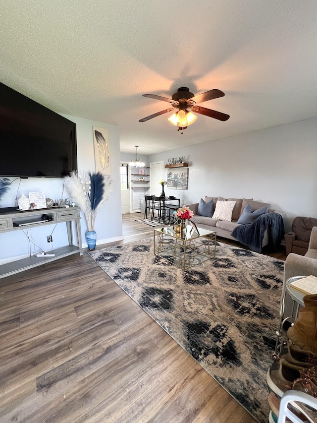 108 Josephines Ct, Oak Grove, KY 42262 - living room featuring a ceiling fan, wood finished floors, a chandelier, a textured ceiling, and baseboards