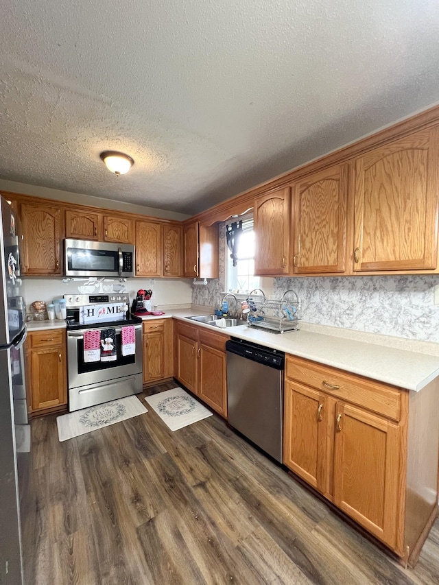 108 Josephines Ct, Oak Grove, KY 42262 - kitchen featuring stainless steel appliances, a sink, dark wood-style flooring, light countertops, and a textured ceiling