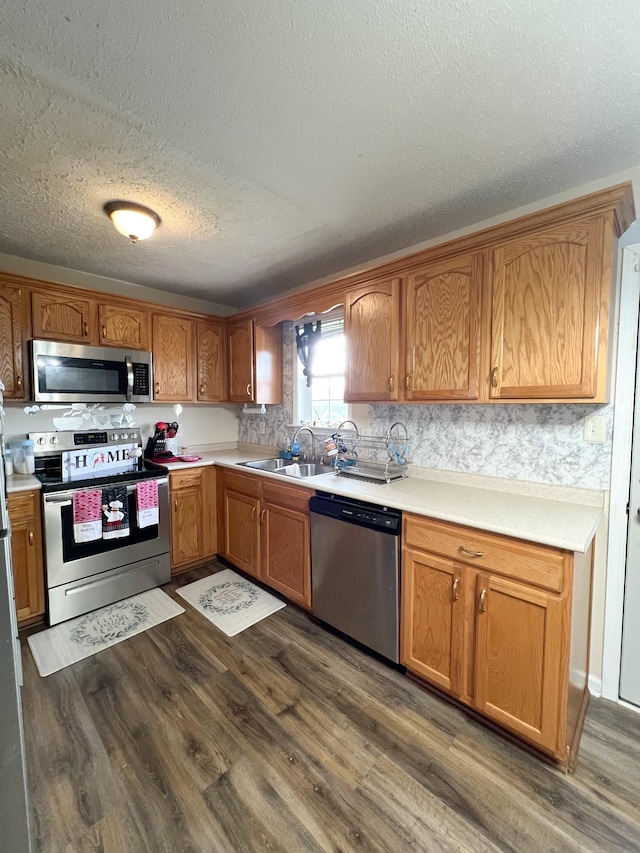 108 Josephines Ct, Oak Grove, KY 42262 - kitchen featuring stainless steel appliances, dark wood-style flooring, a sink, a textured ceiling, and light countertops