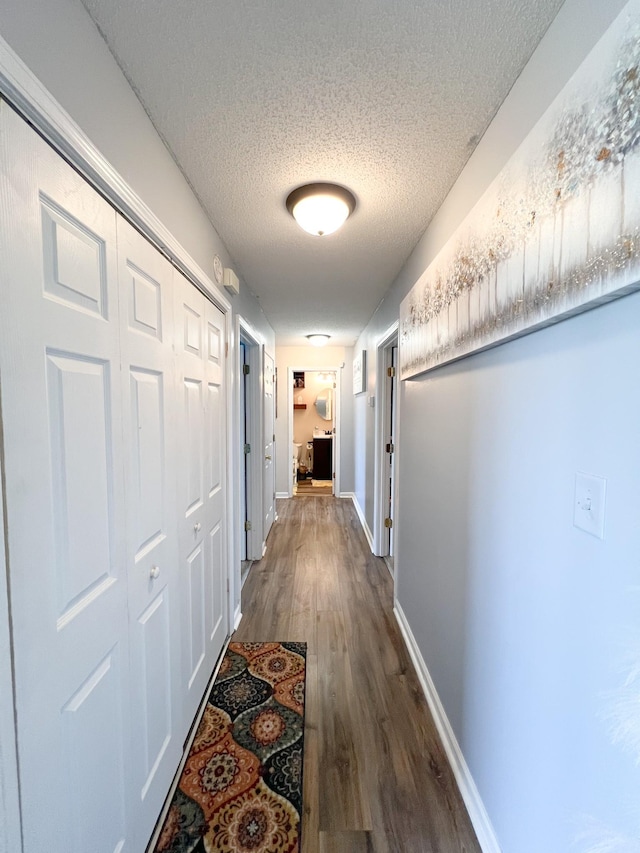 108 Josephines Ct, Oak Grove, KY 42262 - hallway featuring a textured ceiling, dark wood-style floors, and baseboards