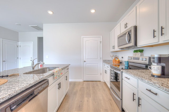336 Ryan Rd, Chapel Hill, TN 37034 - kitchen featuring stainless steel appliances, light wood-type flooring, white cabinetry, light stone counters, and recessed lighting