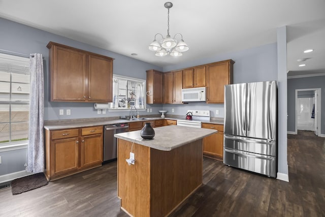 1305 Decatur Cir, Franklin, TN 37067 - kitchen with appliances with stainless steel finishes, dark wood-style flooring, brown cabinets, baseboards, and a chandelier