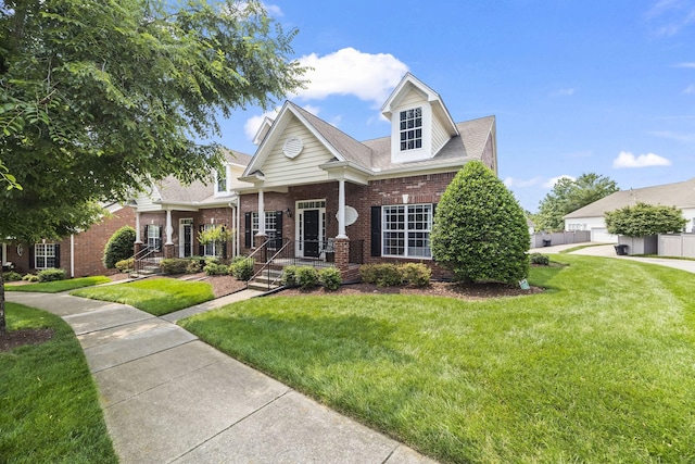 1305 Decatur Cir, Franklin, TN 37067 - view of front of home with brick siding, a front yard, and covered porch