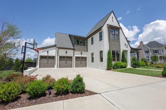 2026 Eliot Rd, Franklin, TN 37064 - view of side of property with concrete driveway, a garage, and stucco siding
