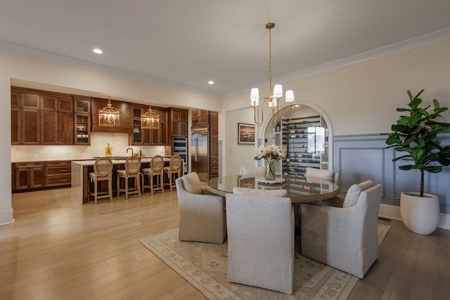 2026 Eliot Rd, Franklin, TN 37064 - dining space with ornamental molding, light wood finished floors, a chandelier, recessed lighting, and a wainscoted wall