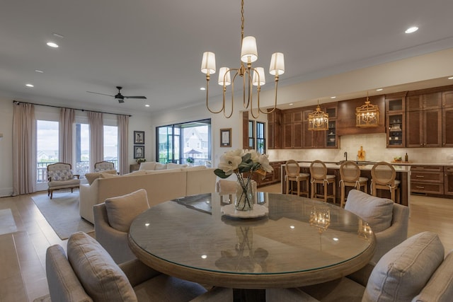 2026 Eliot Rd, Franklin, TN 37064 - dining room featuring recessed lighting, light wood-style flooring, ornamental molding, ceiling fan, and bar