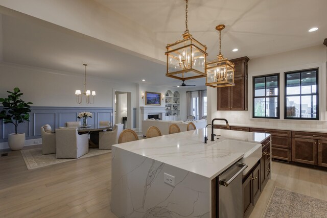 2026 Eliot Rd, Franklin, TN 37064 - kitchen featuring a chandelier, a sink, light wood finished floors, dishwasher, and a wainscoted wall