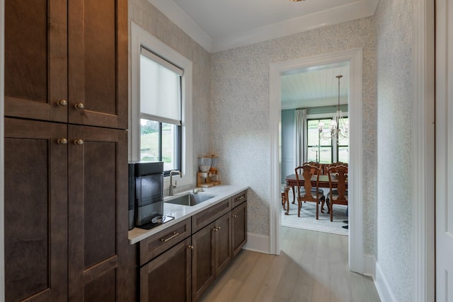 2026 Eliot Rd, Franklin, TN 37064 - bar area with a sink, light wood finished floors, plenty of natural light, a chandelier, and wallpapered walls