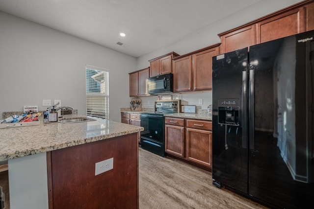 4113 Saddlecreek Way, Antioch, TN 37013 - kitchen featuring black appliances, a sink, light wood-style floors, light stone counters, and recessed lighting