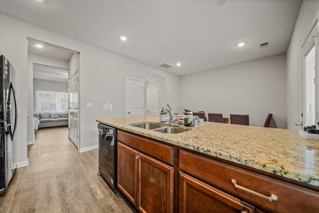 4113 Saddlecreek Way, Antioch, TN 37013 - kitchen featuring a sink, black dishwasher, light wood-style flooring, light stone countertops, and recessed lighting