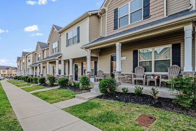4113 Saddlecreek Way, Antioch, TN 37013 - multi unit property featuring a porch, a residential view, stone siding, and a front lawn