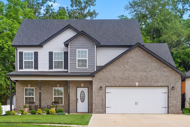 324 Kildeer Dr, Clarksville, TN 37040 - view of front of house with brick siding, concrete driveway, a porch, and a garage