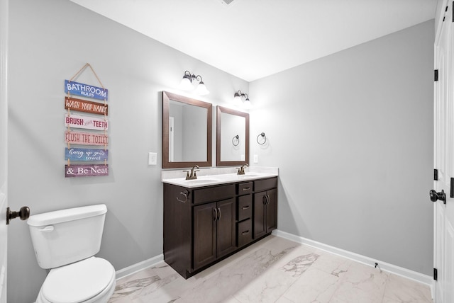 324 Kildeer Dr, Clarksville, TN 37040 - bathroom with marble look tile flooring, double vanity, toilet, and baseboards