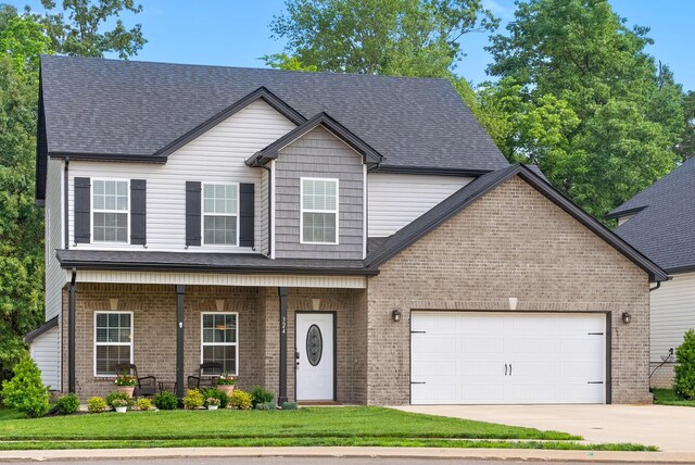 324 Kildeer Dr, Clarksville, TN 37040 - view of front of property featuring brick siding, concrete driveway, a garage, covered porch, and roof with shingles