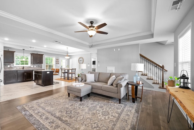 324 Kildeer Dr, Clarksville, TN 37040 - living room with a tray ceiling, a ceiling fan, light wood-style floors, stairway, and ornamental molding