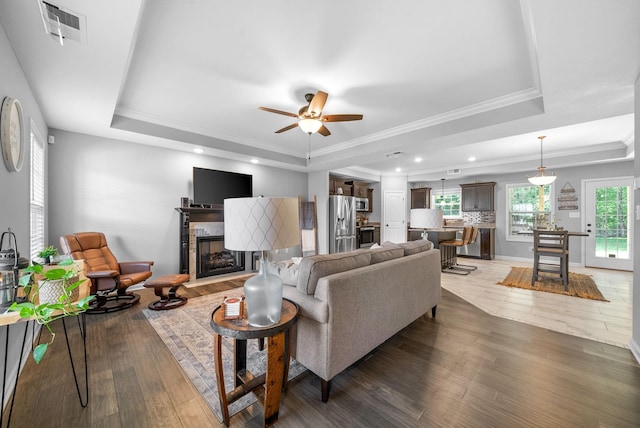 324 Kildeer Dr, Clarksville, TN 37040 - living room featuring a tray ceiling, light wood-type flooring, crown molding, a ceiling fan, and a high end fireplace