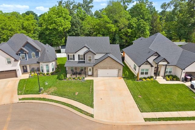 324 Kildeer Dr, Clarksville, TN 37040 - view of front of house with driveway, a front lawn, covered porch, roof with shingles, and a garage