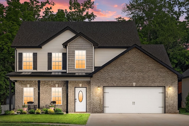 324 Kildeer Dr, Clarksville, TN 37040 - view of front facade with concrete driveway, brick siding, a garage, and roof with shingles