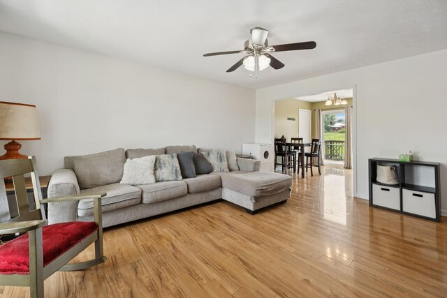 1809 Mosley Ferry Rd, Chapmansboro, TN 37035 - living room featuring a ceiling fan, light wood-style floors, and a chandelier