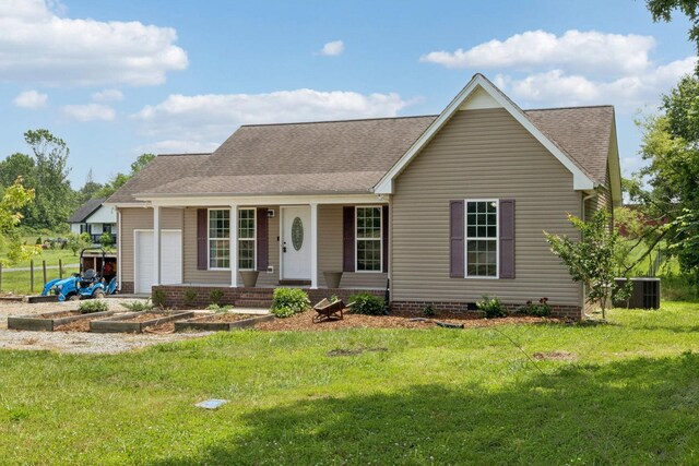 1809 Mosley Ferry Rd, Chapmansboro, TN 37035 - view of front of home featuring covered porch, cooling unit, a front yard, a shingled roof, and a garage