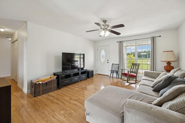 1809 Mosley Ferry Rd, Chapmansboro, TN 37035 - living area with light wood-style floors, a ceiling fan, and baseboards