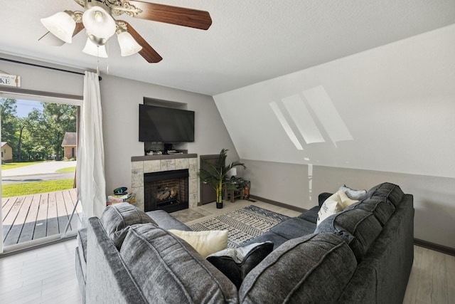 117 Sparrow Ln, Dover, TN 37058 - living room with ceiling fan, a skylight, wood finished floors, a fireplace, and vaulted ceiling