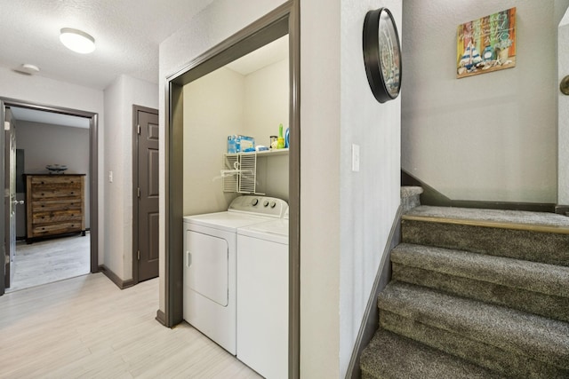 117 Sparrow Ln, Dover, TN 37058 - laundry area featuring separate washer and dryer, light wood-style flooring, and a textured ceiling