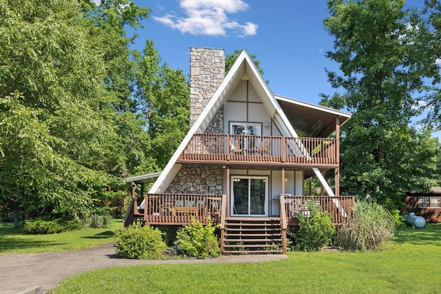 117 Sparrow Ln, Dover, TN 37058 - view of front facade featuring a chimney, a front lawn, a balcony, a wooden deck, and stone siding