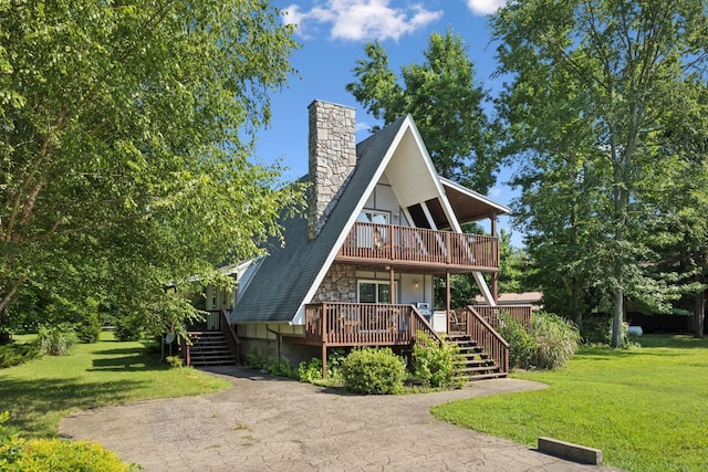 117 Sparrow Ln, Dover, TN 37058 - a-frame style home featuring stairs, a deck, a front lawn, and a chimney