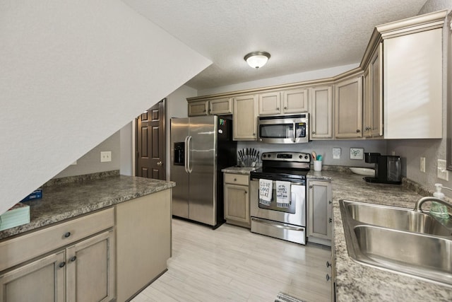 117 Sparrow Ln, Dover, TN 37058 - kitchen featuring stainless steel appliances, a textured ceiling, and light wood finished floors