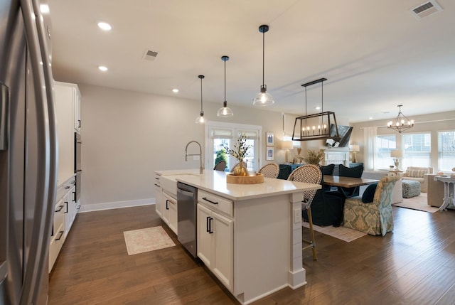 3309 Longstalk Rd, Antioch, TN 37013 - kitchen featuring stainless steel appliances, open floor plan, a kitchen bar, dark wood-style floors, and recessed lighting