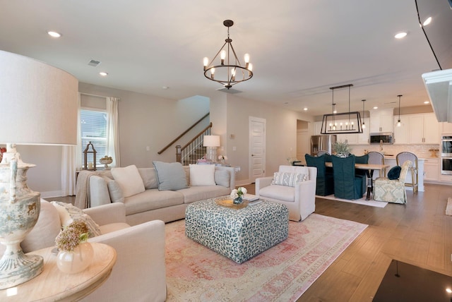 3309 Longstalk Rd, Antioch, TN 37013 - living area with a chandelier, wood finished floors, stairs, and recessed lighting