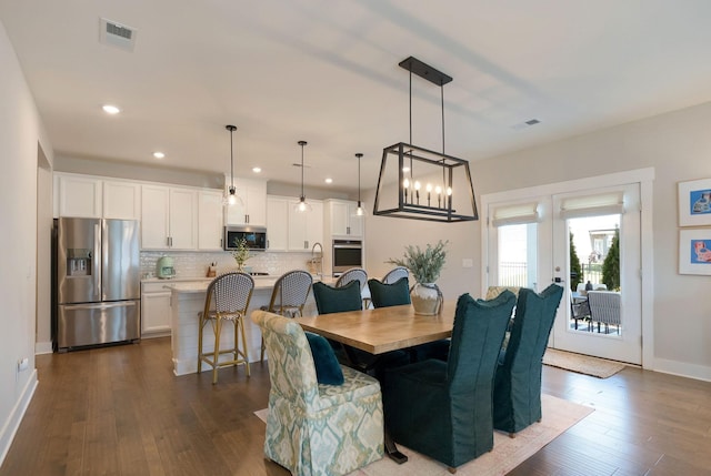 3309 Longstalk Rd, Antioch, TN 37013 - dining area featuring dark wood finished floors, recessed lighting, baseboards, a chandelier, and french doors