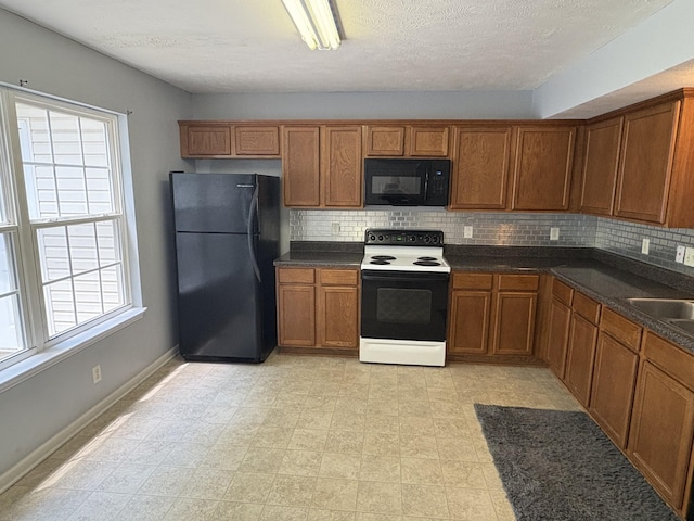 3236 Prater Ct, Murfreesboro, TN 37128 - kitchen featuring black appliances, brown cabinets, backsplash, dark countertops, and a textured ceiling
