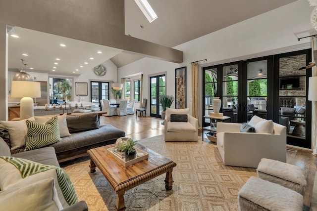 238 Pelham Dr, Brentwood, TN 37027 - living room featuring high vaulted ceiling, recessed lighting, light wood-style flooring, and a skylight