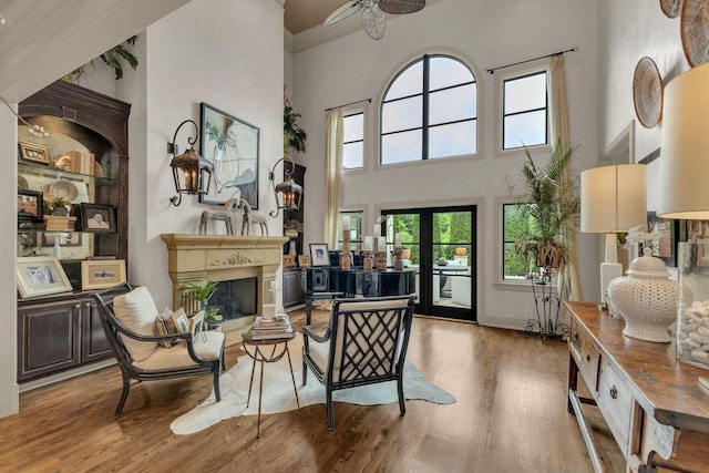 238 Pelham Dr, Brentwood, TN 37027 - living room featuring a high ceiling, wood finished floors, a fireplace, a ceiling fan, and built in features